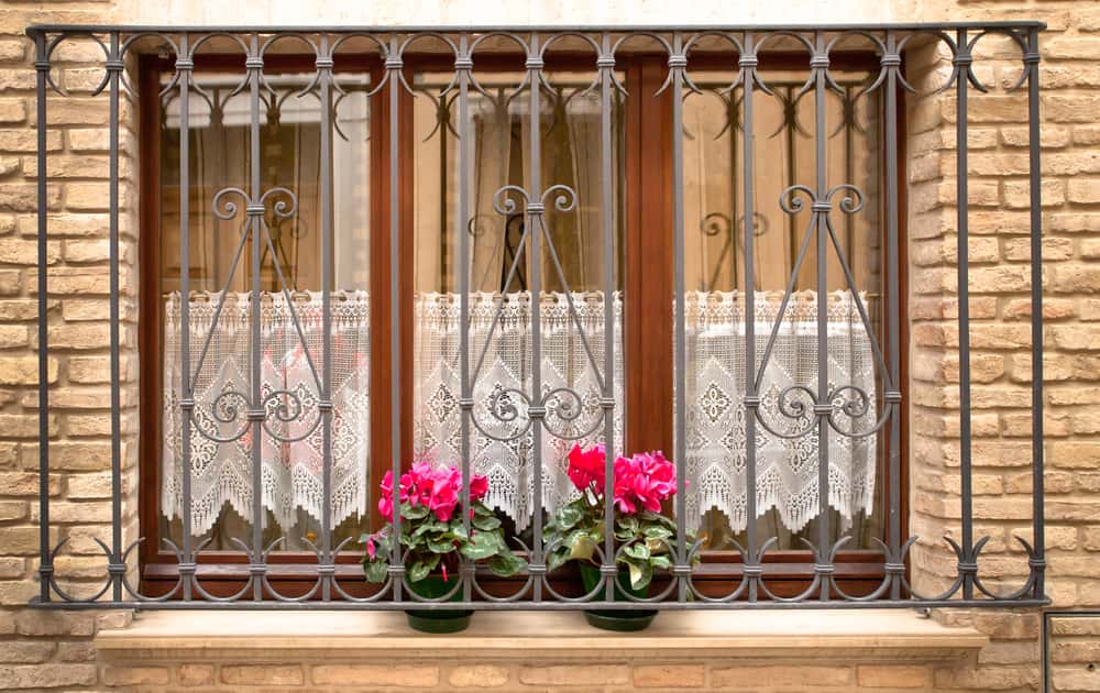 wooden windows with a designer grill
