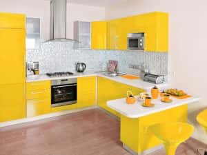 Vibrant affordable modular kitchen designs with glossy yellow cabinets and breakfast bar