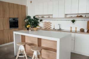 Minimal budget-friendly modular kitchen designs with white cabinets and wood textures