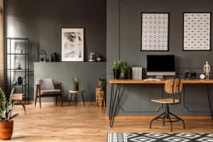 patterned posters above desk computer monitor