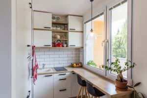 Bright budget-friendly modular kitchen designs with natural light and wood counter