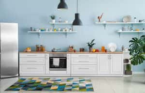 Stylish low cost modular kitchen designs with white cabinets and open blue wall shelves