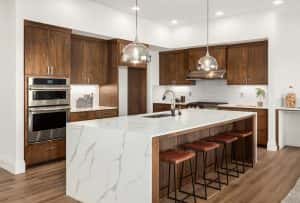 Elegant luxury modular kitchen with marble island and warm wooden cabinetry
