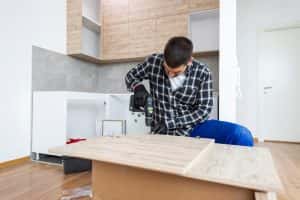 Carpenter Finalizing Assembly Kitchen Shelf