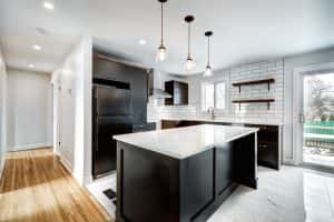 Bright affordable modular kitchen designs with black cabinets and marble island
