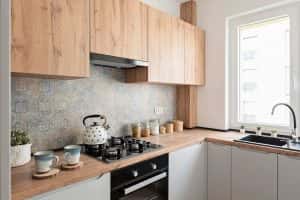 L-shaped modular kitchen with wooden cabinets and elegant countertop