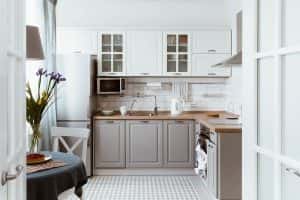 Cozy middle class simple kitchen design with grey lower cabinets and tiled floor