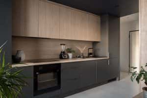 Modern simple kitchen designs with matte black cabinets and light wood upper storage
