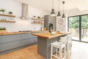 Modern simple kitchen designs with grey cabinets and a wood-finish island counter