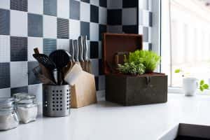 Minimal simple kitchen rack design with knife holder and herbs on white countertop
