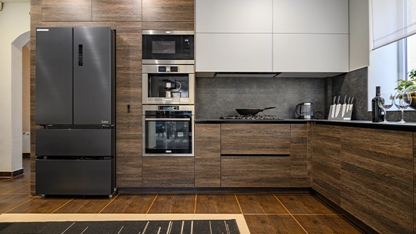 Modern kitchen triangle layout with fridge stove and oven in a sleek wood finish design