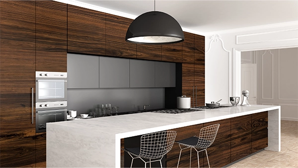 Luxurious modern kitchen cupboards in dark wood with marble island and sleek grey cabinets