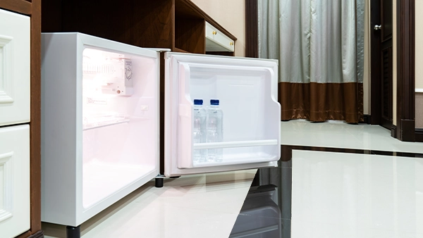 Undercounter modern kitchen cupboards with built in mini fridge and glossy tiled flooring
