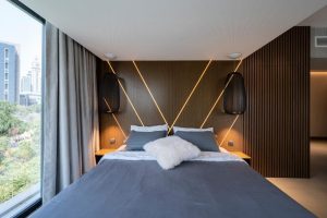 Different types of wall panels in stylish modern bedroom space 