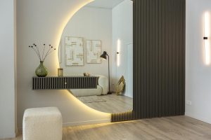 Wall paneling materials with slatted modern entryway and round mirror 