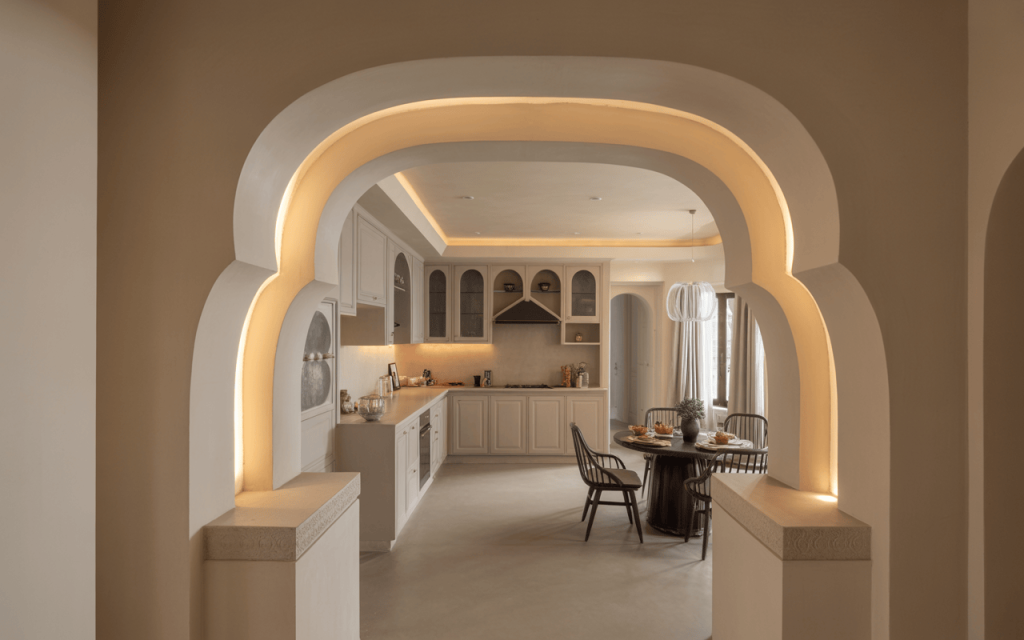 Elegant kitchen arch design with layered curves and cozy neutral-toned interiors