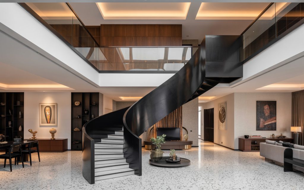 Elegant steel spiral staircase design in a luxury double-height living room