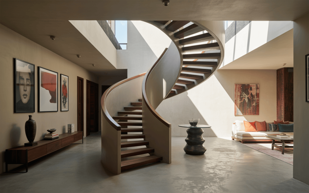 Sculptural luxury modern curved staircase design in sunlit contemporary home