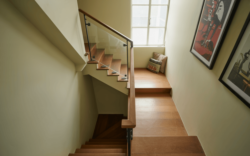 Compact modern glass staircase design with wood steps in natural light