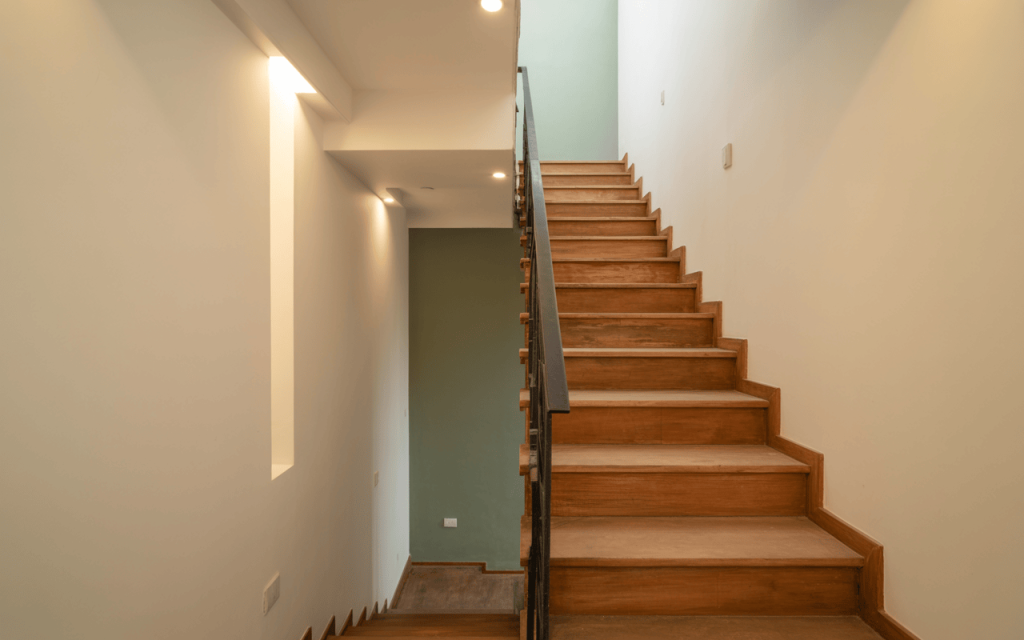Minimal modern staircase design with wooden treads and slim black railing