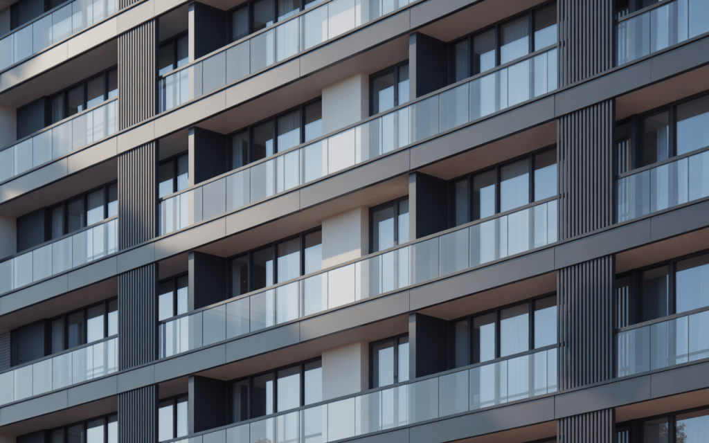 Elegant glass balcony grill design on modern building with sleek black frame accents