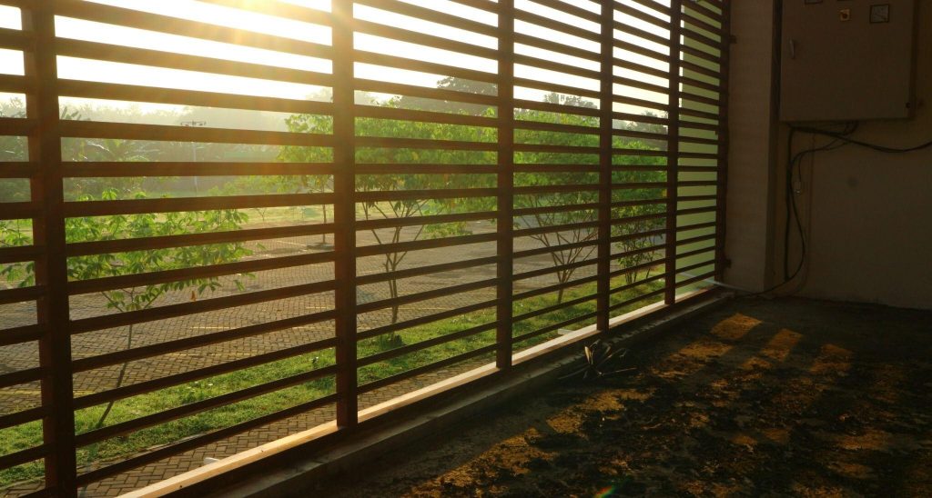 Sunlit latest modern window grill design offering open outdoor views and sleek appeal