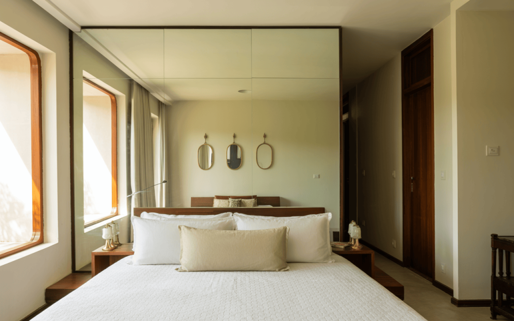 Luxe master bedroom wall decor with a floor-to-ceiling upholstered headboard panel