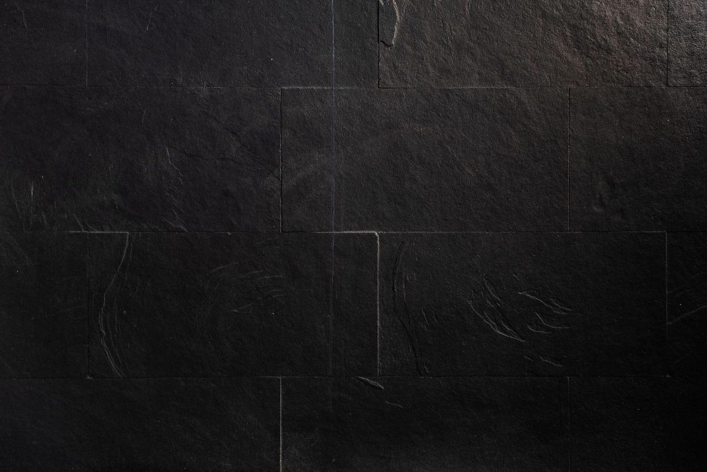 Luxury master bedroom wall tiles design with dark stone texture for bold interiors