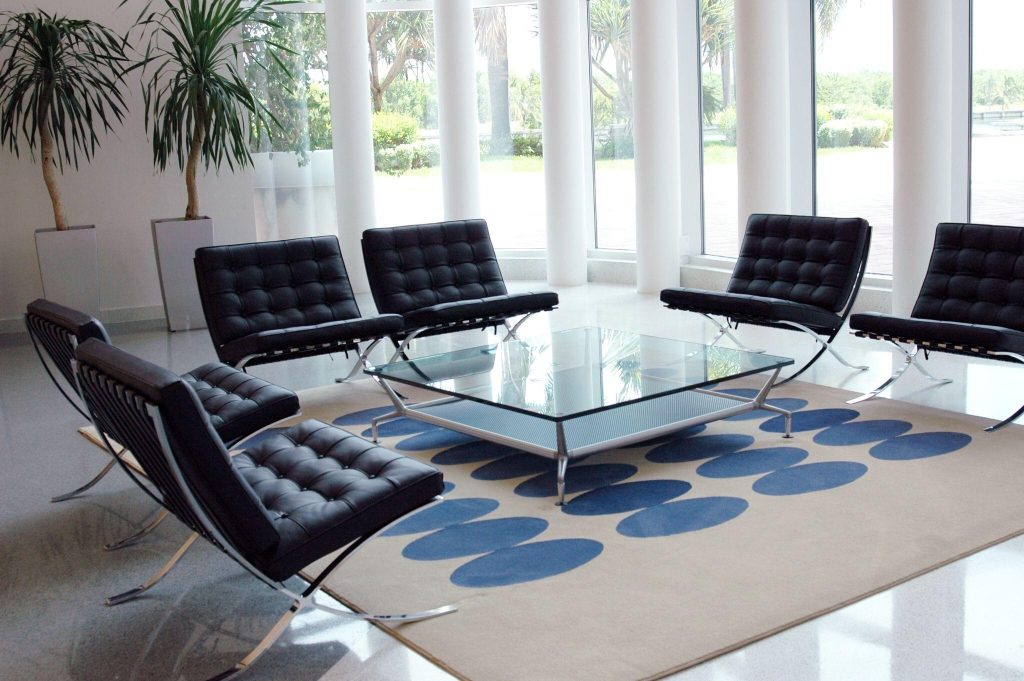 Elegant modern sofa table design with glass top in a stylish contemporary lounge