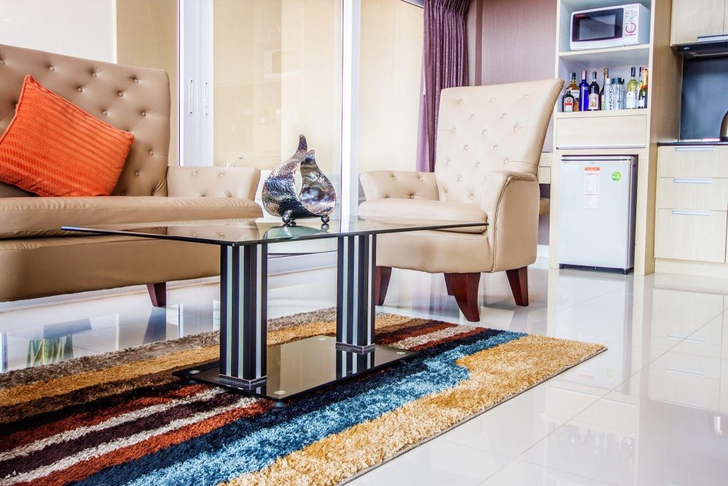 Stylish glass sofa table design with sleek black frame in a modern living room