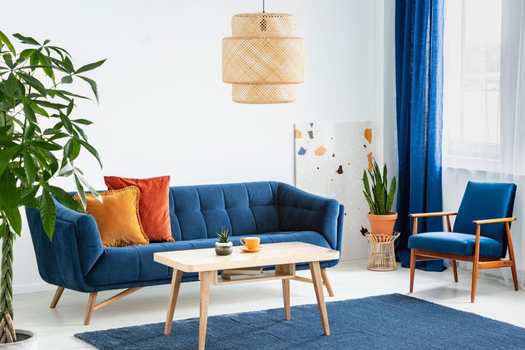 Stylish wood sofa table design paired with a modern blue sofa in a cozy living room
