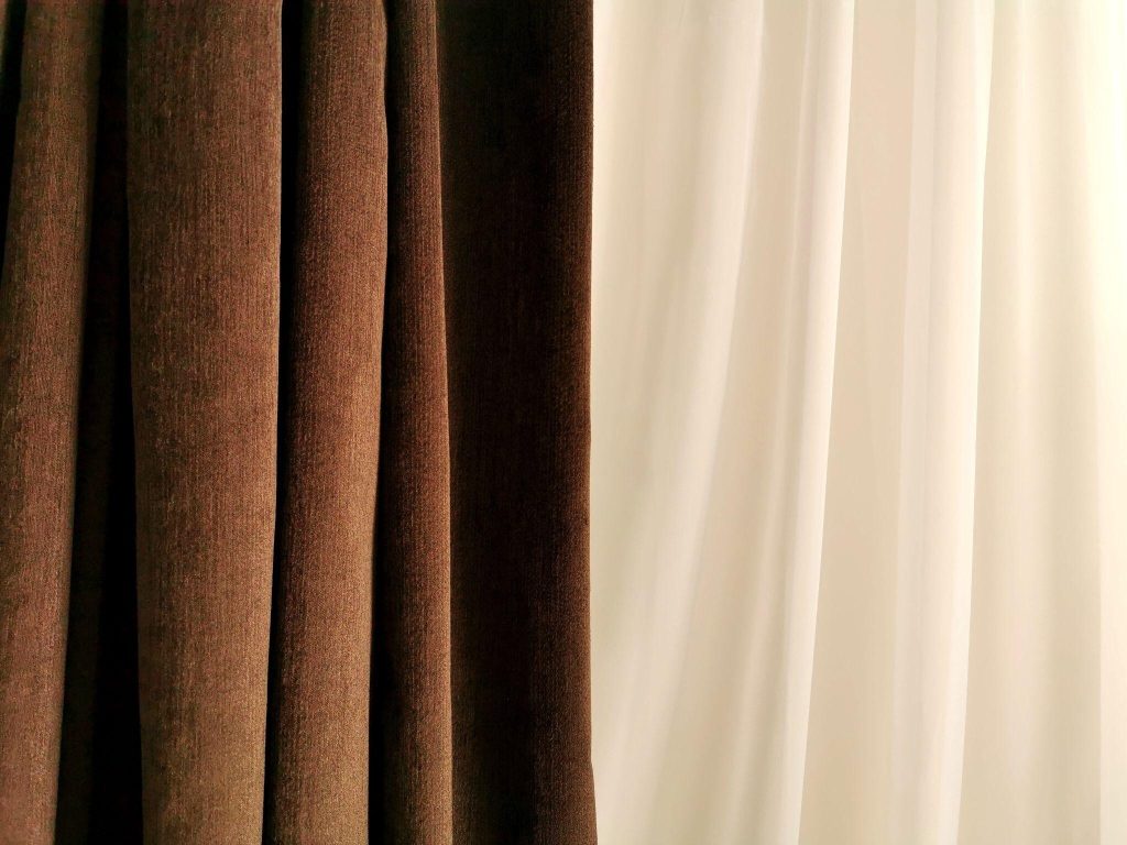Elegant small bedroom curtain ideas with brown and cream fabric for cozy interiors