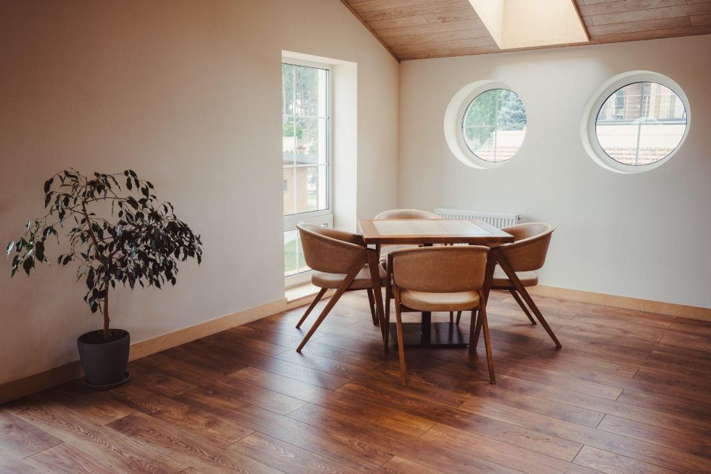 Modern window frame design with circular windows brightening a cosy dining space