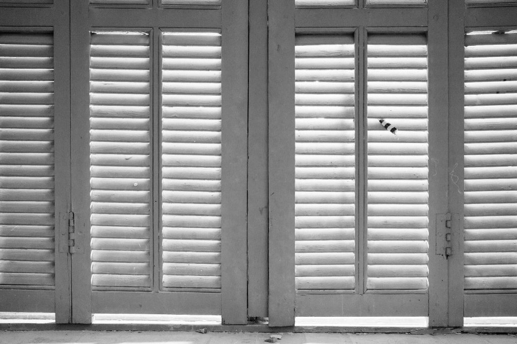 Vintage sliding window frame design with wooden shutters in classic style