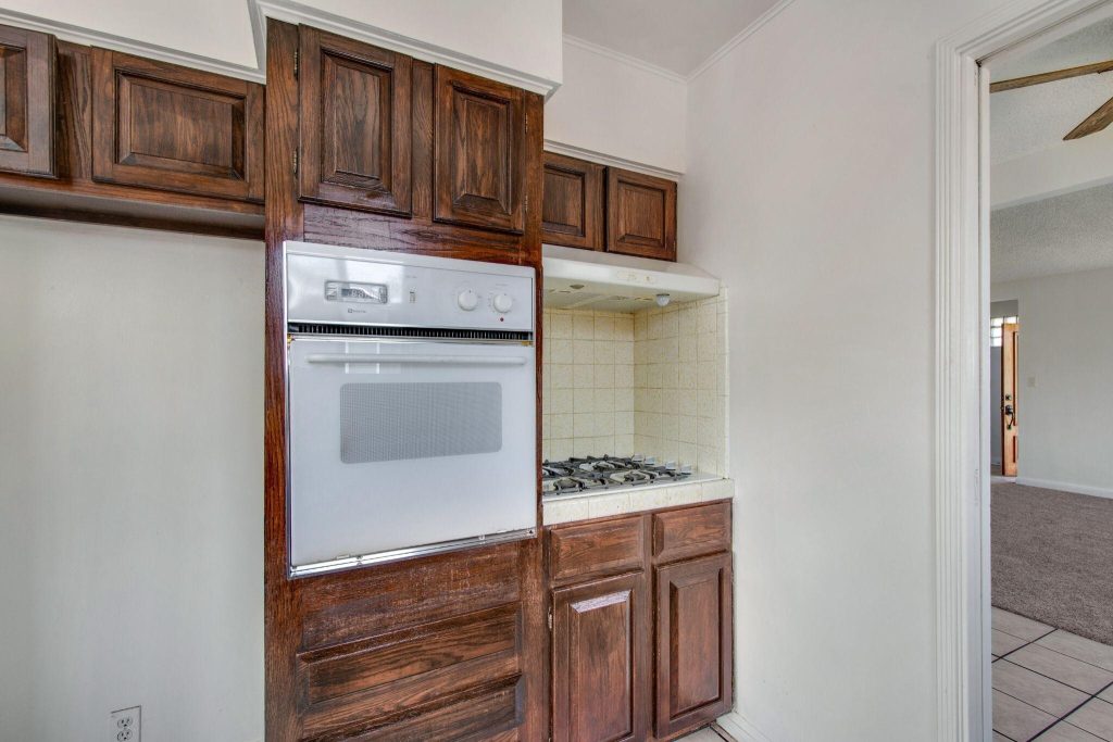 Classic kitchen design trends with wooden cabinets and built-in oven setup