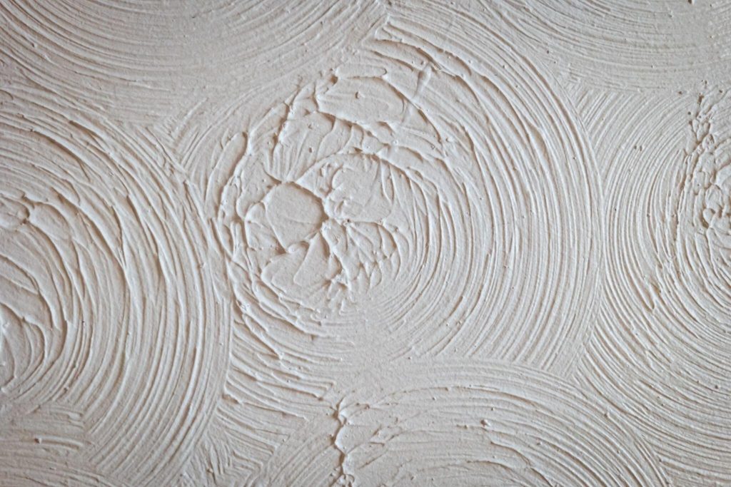 Elegant textured ceiling trends with swirl plaster patterns adding depth and character
