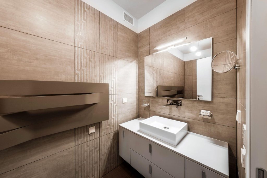 Elegant modern bathroom tile trends with sleek vanity, textured wall tiles and mirror lighting
