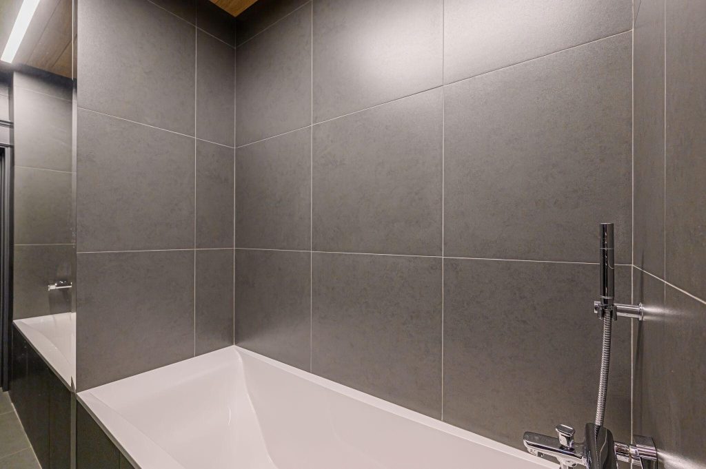 Stylish modern bathroom tile trends showcasing sleek gray walls and minimalist design