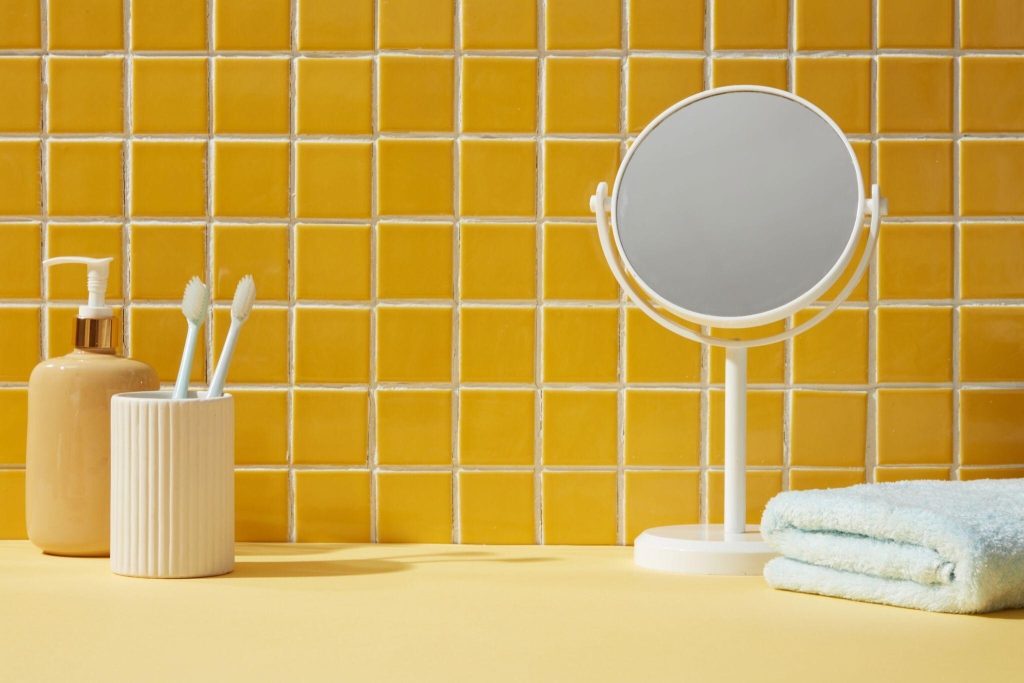 Vibrant trending bathroom tiles design with bright yellow backsplash and modern setup