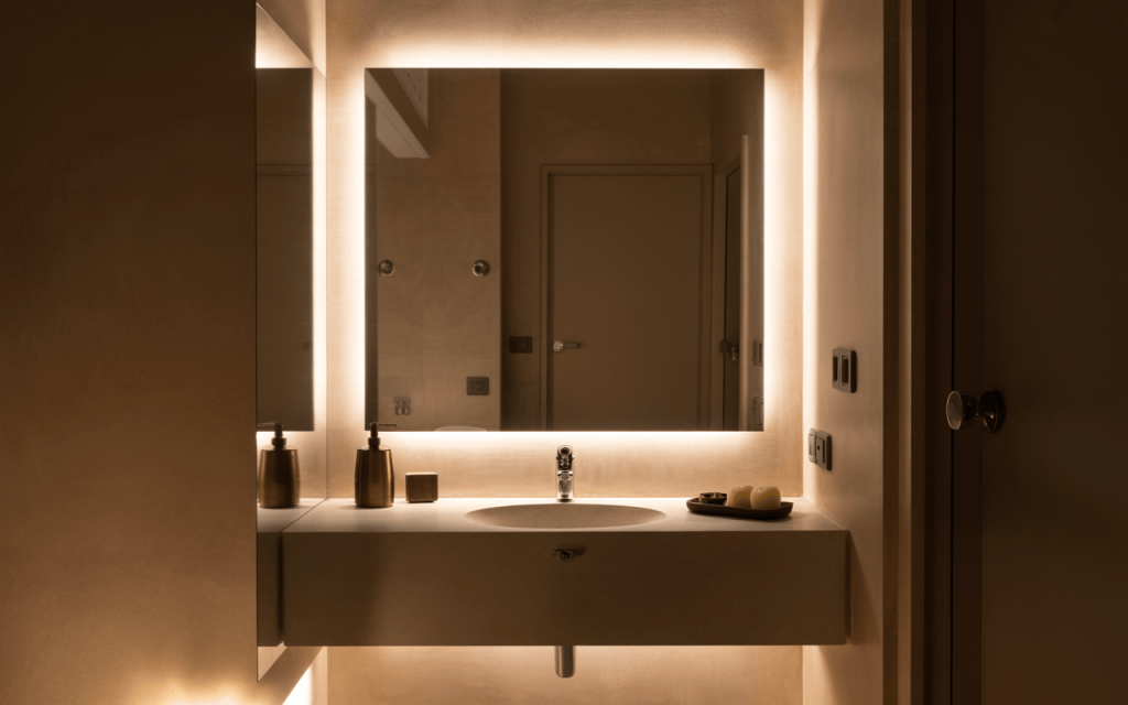 Elegant wash basin mirror design with light creating warm modern ambiance