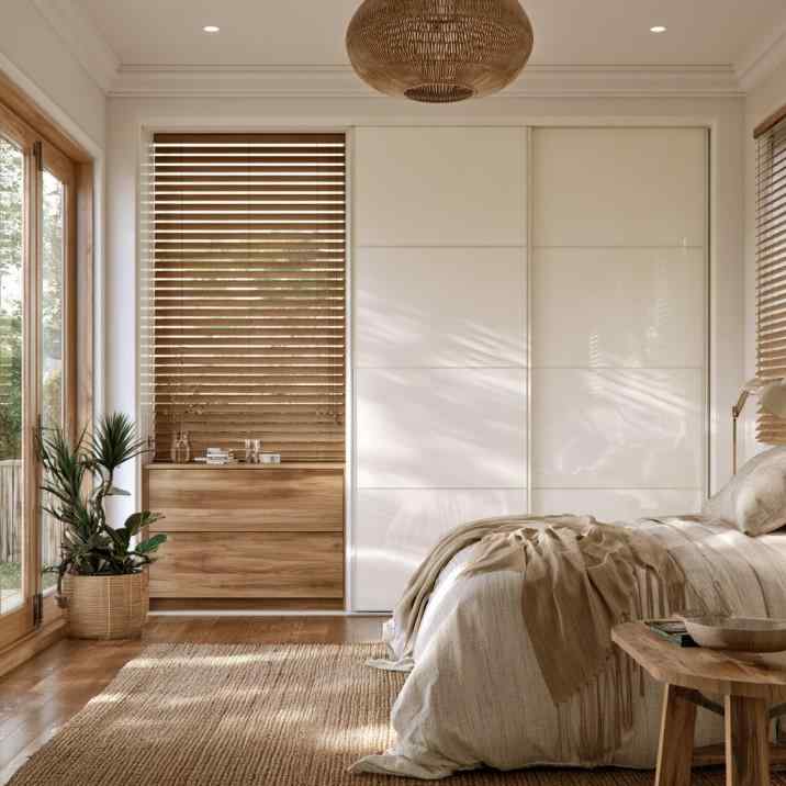 Simple white sliding wardrobe design in small bedroom