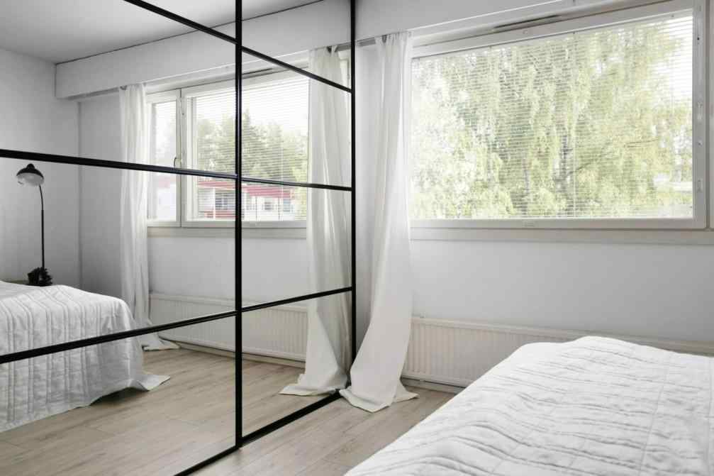  Black-framed mirror sliding wardrobe in modern bedroom