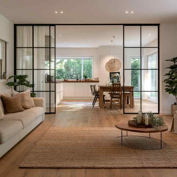 Black-framed clear glass sliding door for open kitchen