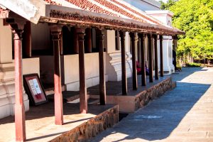 Tamil Nadu home designs showcasing classic veranda with wooden pillars and sloping red-tiled roofing style
