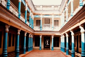 Traditional Tamil Nadu house design with open courtyard and blue pillars showcasing Chettinad architectural elegance
