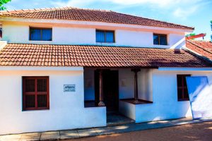 Traditional Tamil Nadu house designs showcasing rustic tiled roofing and simple white-painted structure