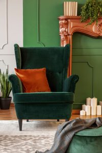 Modern Tamil Nadu house designs featuring emerald green armchair decor and elegant earthy living room tones