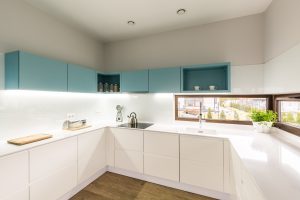 Kitchen corner units with sleek modular cabinets, bright lighting and smart space saving layout