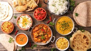 Delicious party ideas for holi feast with Indian dishes, curry, rice, naan, and festive spread