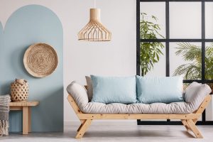 Minimalist sofa designs wooden frame sofa with beige cushions and soft blue pillows in airy modern space